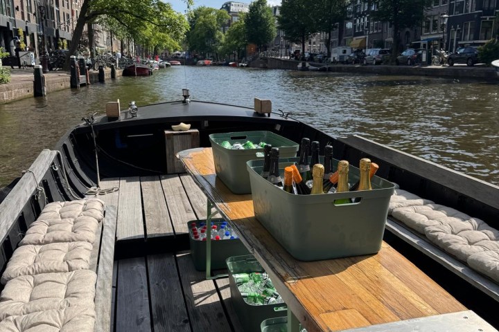 Open boat with drinks on a canal under clear skies