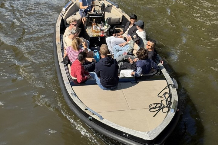 Group of people sitting on a boat in a river.